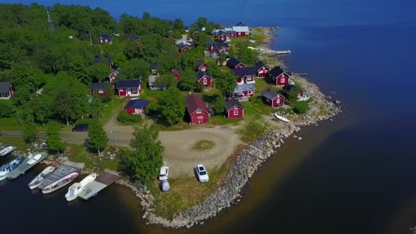 A beautiful view of small Scandinavian houses on the Baltic Sea shore on a clear sunny day. — Stock Video