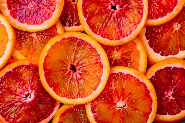 Background made of ripe juicy blood orange slices. — Stock Photo, Image