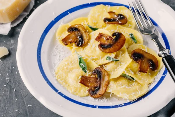 Ravioli pasta with champignon mushrooms and parmesan cheese — Stock Photo, Image
