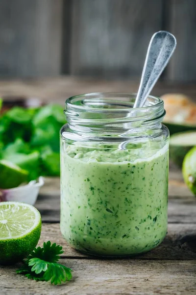 Зеленый салат с авокадо, лаймом и кинзой в стеклянной банке — стоковое фото