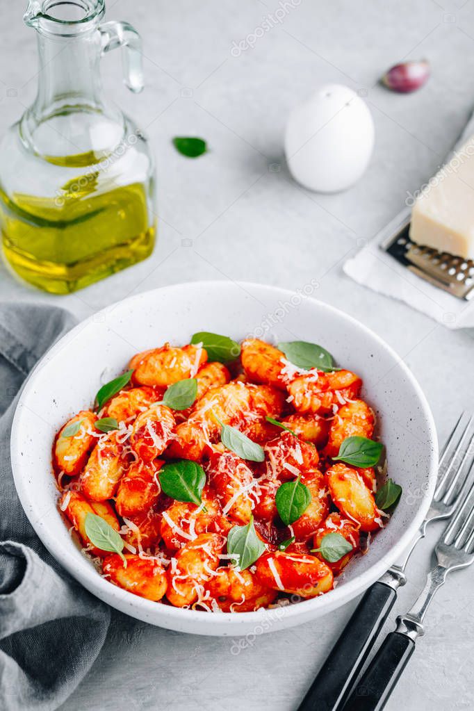 Traditional Italian potato Gnocchi with tomato sauce, parmesan cheese and fresh basil 