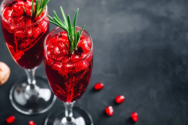 Pomegranate Champagne Cocktail with rosemary on gray concrete stone background — Stock Photo, Image