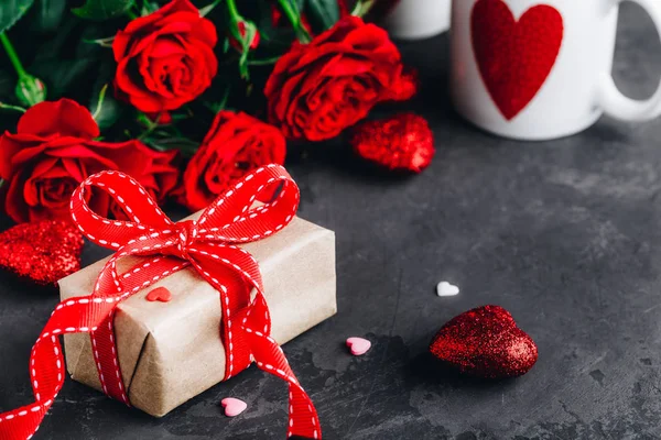 Fondo de San Valentín con rosas rojas, caja actual y corazones rojos — Foto de Stock