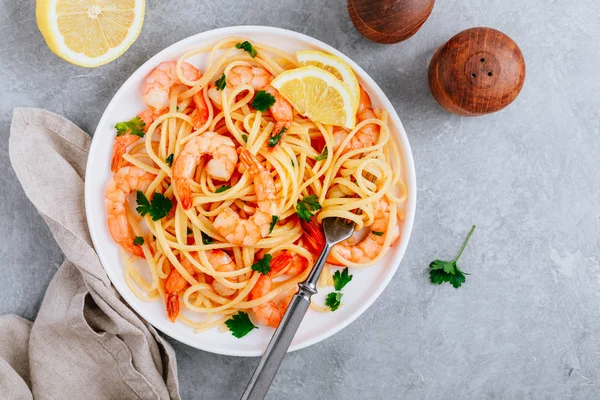 Meeresfrüchte Pasta Spaghetti mit Garnelen und Petersilie auf grauem Steinhintergrund. — Stockfoto