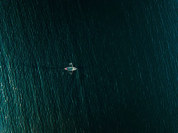 Aerial view of wooden fishing boat in deep blue sea. — Stock Photo, Image