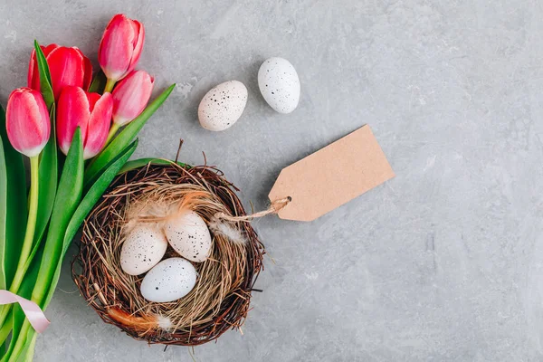 Easter Eggs Nest Pink Tulips Bouquet Gray Stone Background Top — Stock Photo, Image
