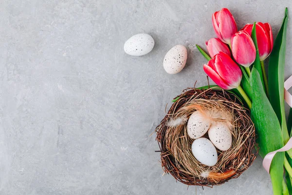 Easter Eggs Nest Pink Tulips Bouquet Gray Stone Background Top — Stock Photo, Image