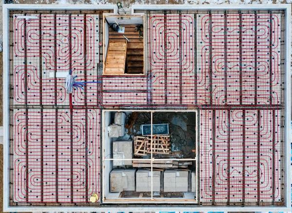 Aerial view of radiant underfloor heating installation in new house construction site