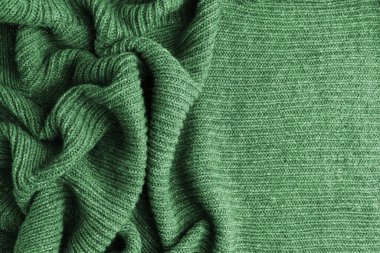 El yapımı yeşil örgü yün doku arka planı. Metin için yer