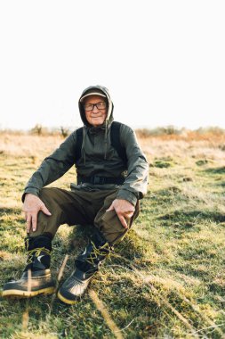 Yaşlı adam sisli ormanda fotoğraf çekiyor..