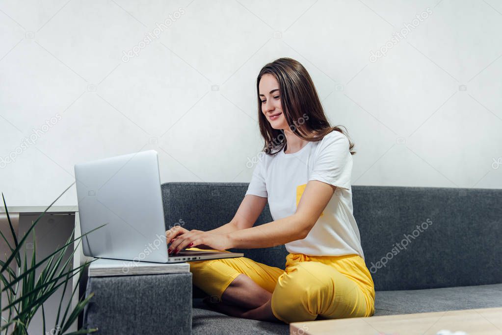 Beautiful freelancer woman using laptop computer at home.