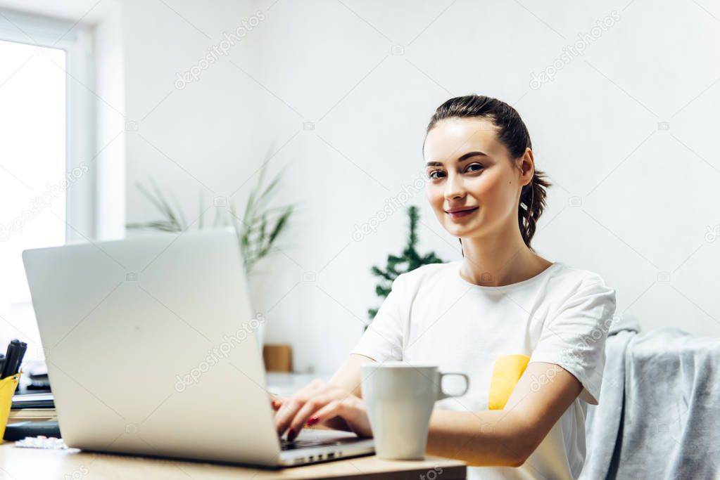 Beautiful freelancer woman using laptop computer at home. 
