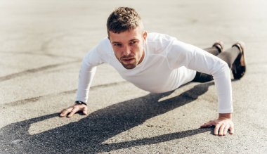 Adam antrenmanı, açık havada itiş kakış. Yakışıklı adam dışarıda şınav çekiyor..