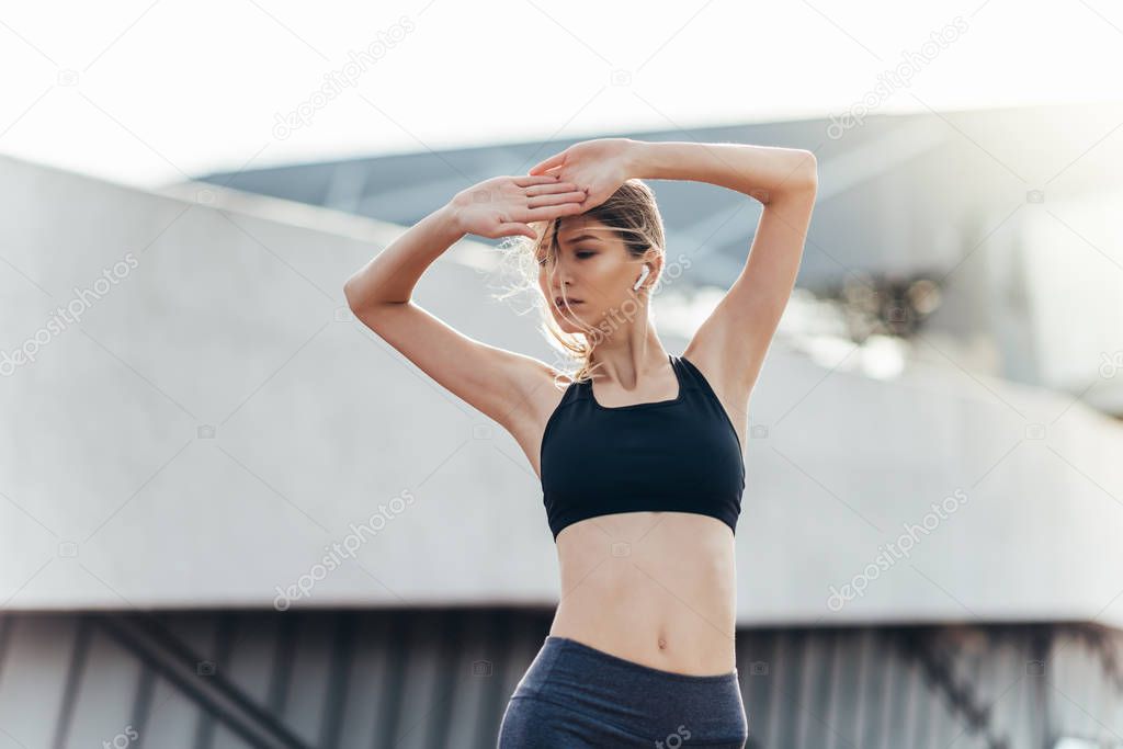 Close up of a fitness woman doing warm up exercises.