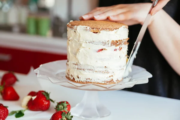 Femme glaçage soigneusement le gâteau — Photo