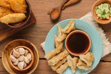Pempek kırsal ahşap masada servis edilir. Pempek, Endonezya 'nın geleneksel gıdasıdır. Balık ve tapyokadan yapılma, tatlı ve özel ekşi sos ya da cuka adı verilen sirke sosuyla servis edilir.
