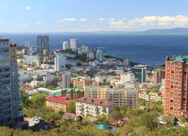 Vladivostok, Russia - September, 18, 2019: Panorama of the central part of the city of Vladivostok from a viewing platform at the top of the Eagle's Nest hill on a clear sunny day.