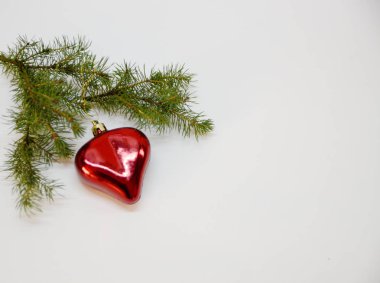 Mutlu noeller. Yeni yıl. Beyaz arka planda yeşil bir ladin dalı ve bayram dekoratif süsleri var..