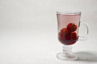 Vitamin, soft drink. On a white background is a glass cup with strawberry aromatic compote of homemade.