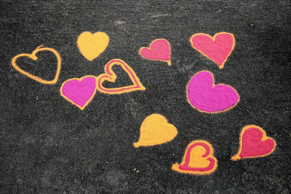 Heart shape sand painting on ground