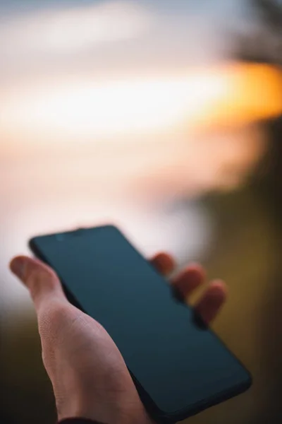 Person holding a beautiful phone in his hand in the outside.