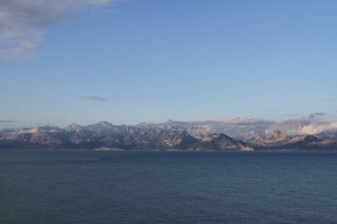Antalya 'daki dağlar ve deniz manzarası karla kaplı dağlarla