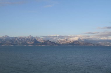 Antalya 'daki dağlar ve deniz manzarası karla kaplı dağlarla