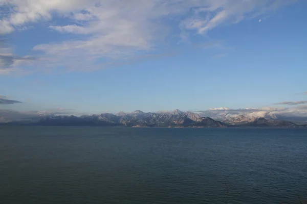 Antalya 'daki dağlar ve deniz manzarası karla kaplı dağlarla