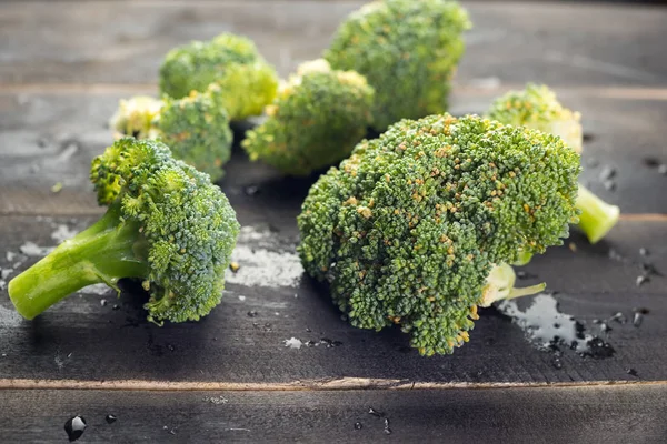 Broccoli on black wooden background — Stock Photo, Image