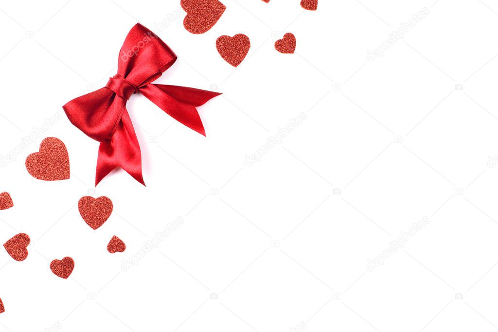 Romantic background with satin red bow and red hearts with sequins