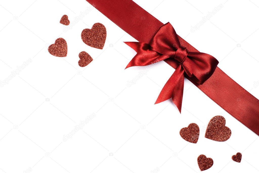 Romantic background with satin red bow and red hearts with sequins. For your text