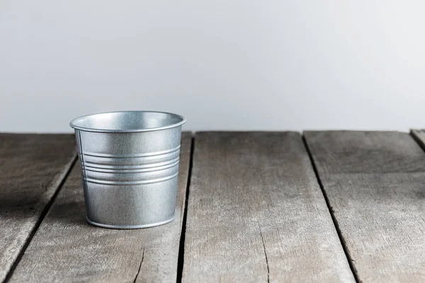 Vintage metal bucket on wooden background — Stock Photo, Image