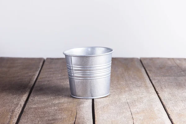 Vintage metal bucket on wooden background — Stock Photo, Image