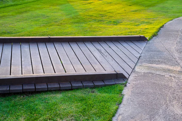 Wood walkway in grass — Stock Photo, Image