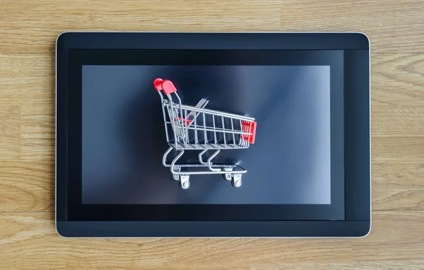 Shopping cart and tablet — Stock Photo, Image