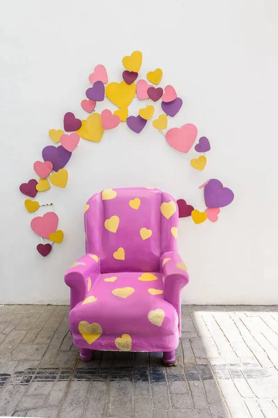 Purple vintage chair with colorful heart decoration — Stock Photo, Image