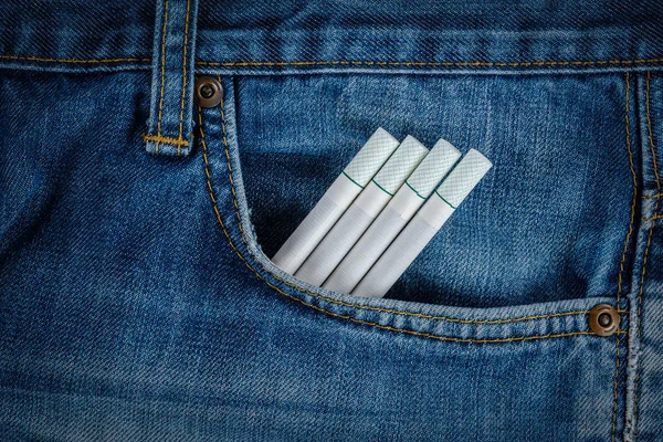 Cigarettes in old blue denim jeans pocket