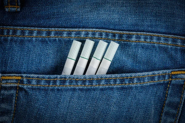 Cigarettes in old blue denim jeans pocket