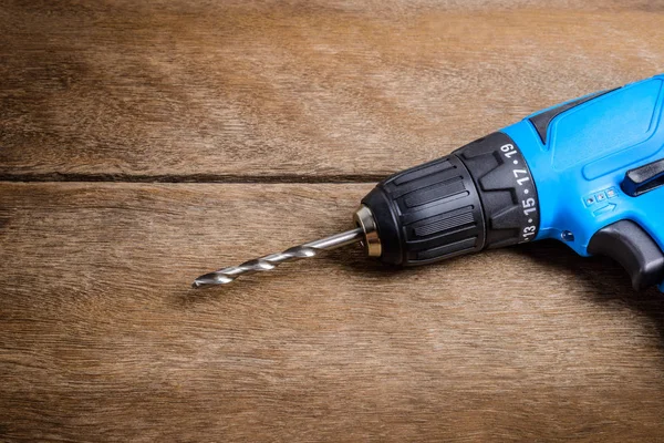 Electric drill on wooden table background and copy space. — Stock Photo, Image
