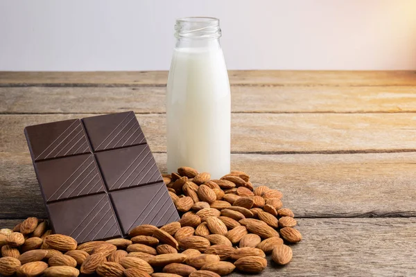 Milk Bottle Chocolate Almond Wooden Background — Stock Photo, Image