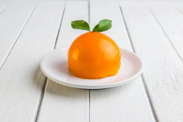 Orange cake on white wooden table — Stock Photo, Image