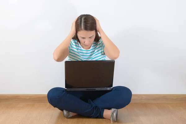 Tired teen woman with laptop sitting — Stock Photo, Image