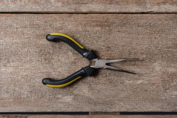Pliers tool pliers on wooden background — Stock Photo, Image