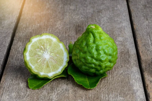 Fresh bergamot fruit on wooden table — Stock Photo, Image