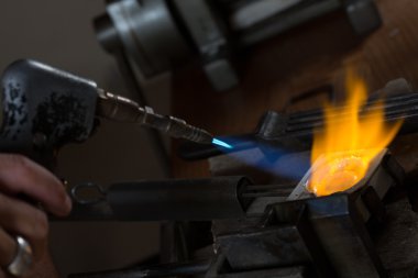 Metal Casting with blowtorch clipart