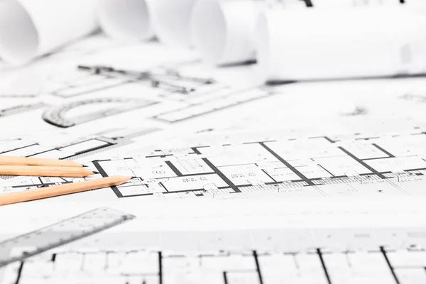 Construction plans with drawing tools on blueprints