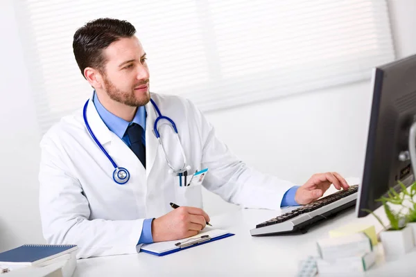 Médico masculino trabajando en la computadora —  Fotos de Stock