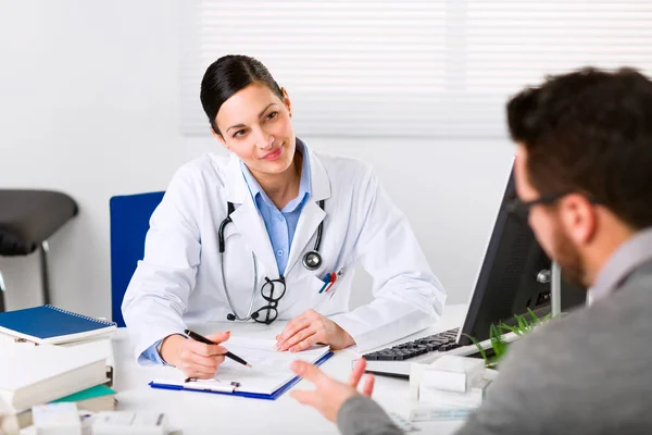 Young female doctor listening intently — Stock Photo, Image