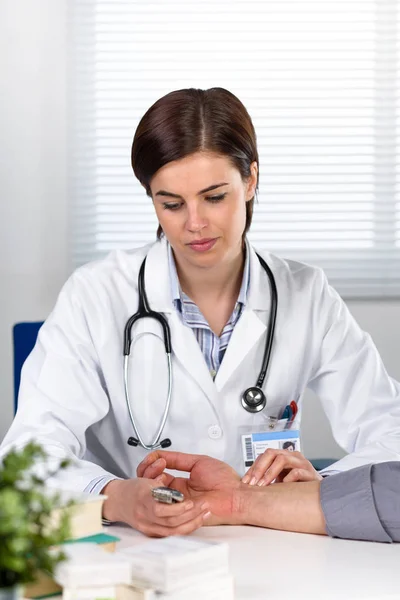 Kobieta lekarz pomiaru bicia serca pacjenta — Zdjęcie stockowe