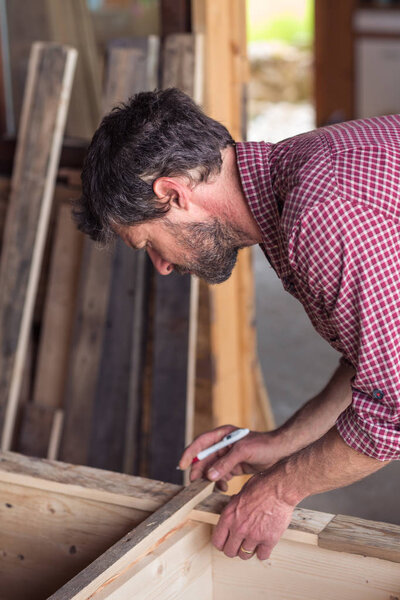 Carpenter working on wooden furniture